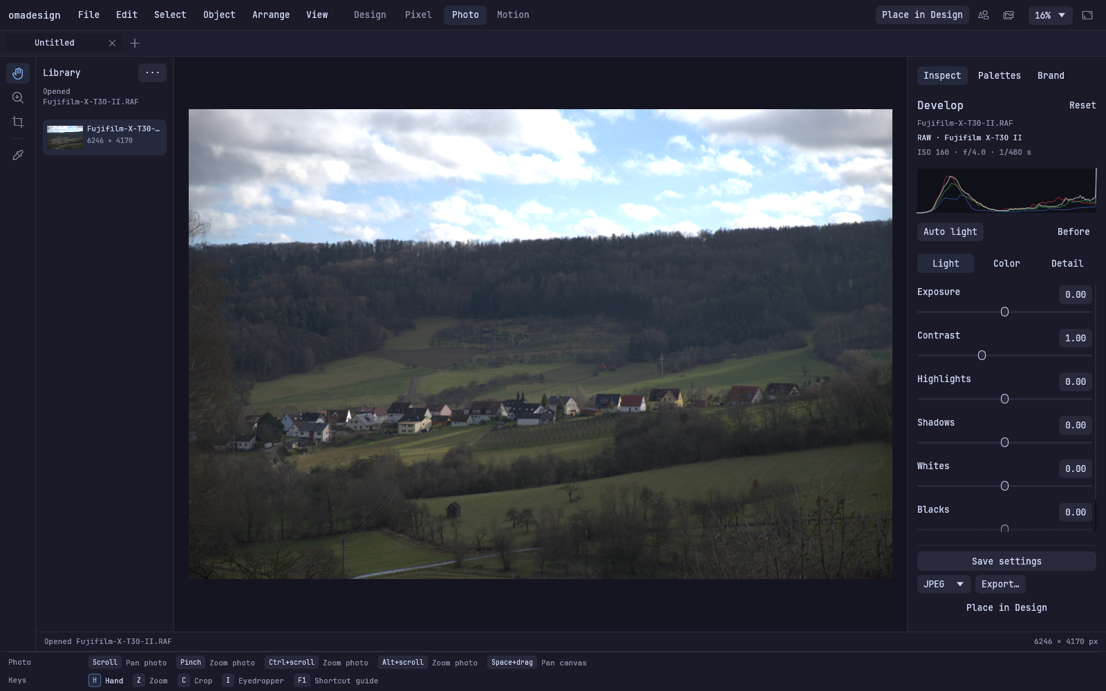 Omadesign Photo workspace developing a Fujifilm RAW landscape, with camera metadata, histogram, and light controls.